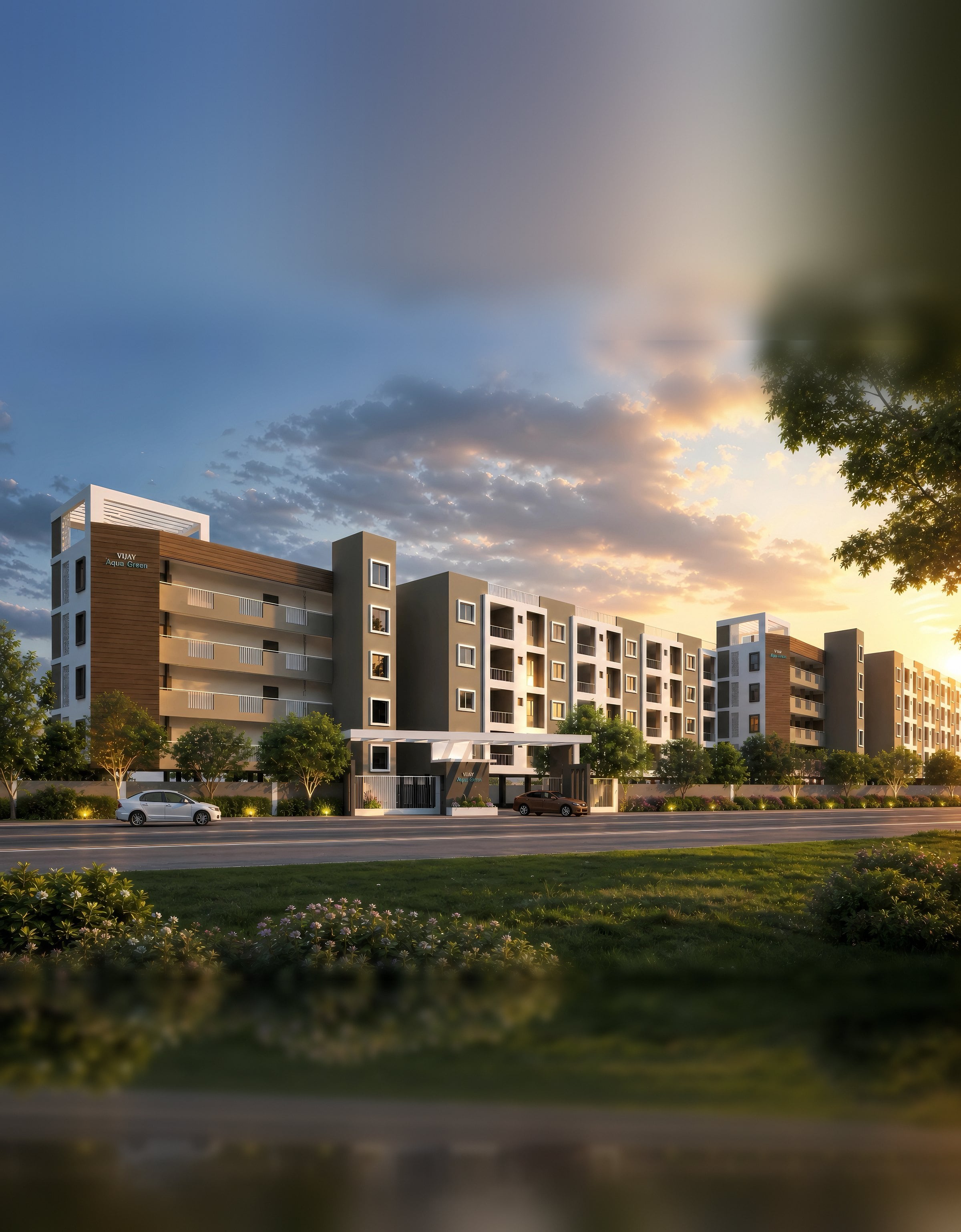 Vijay Aqua Green at sunset, its low blocks running back along the road behind a planted verge